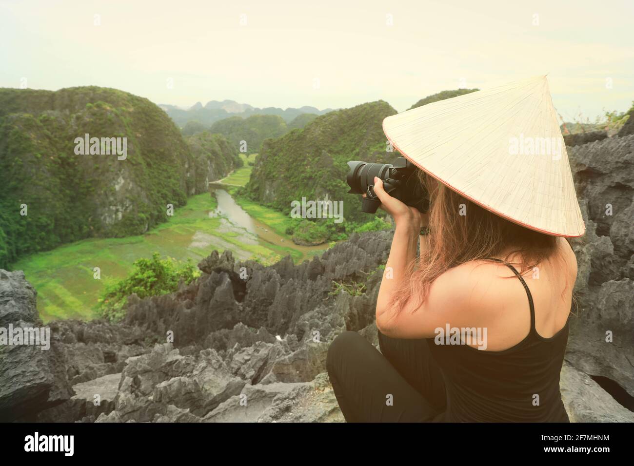 Photographer asian woman holding slr camera professional photography in Ninh Binh, Vietnam Stock Photo