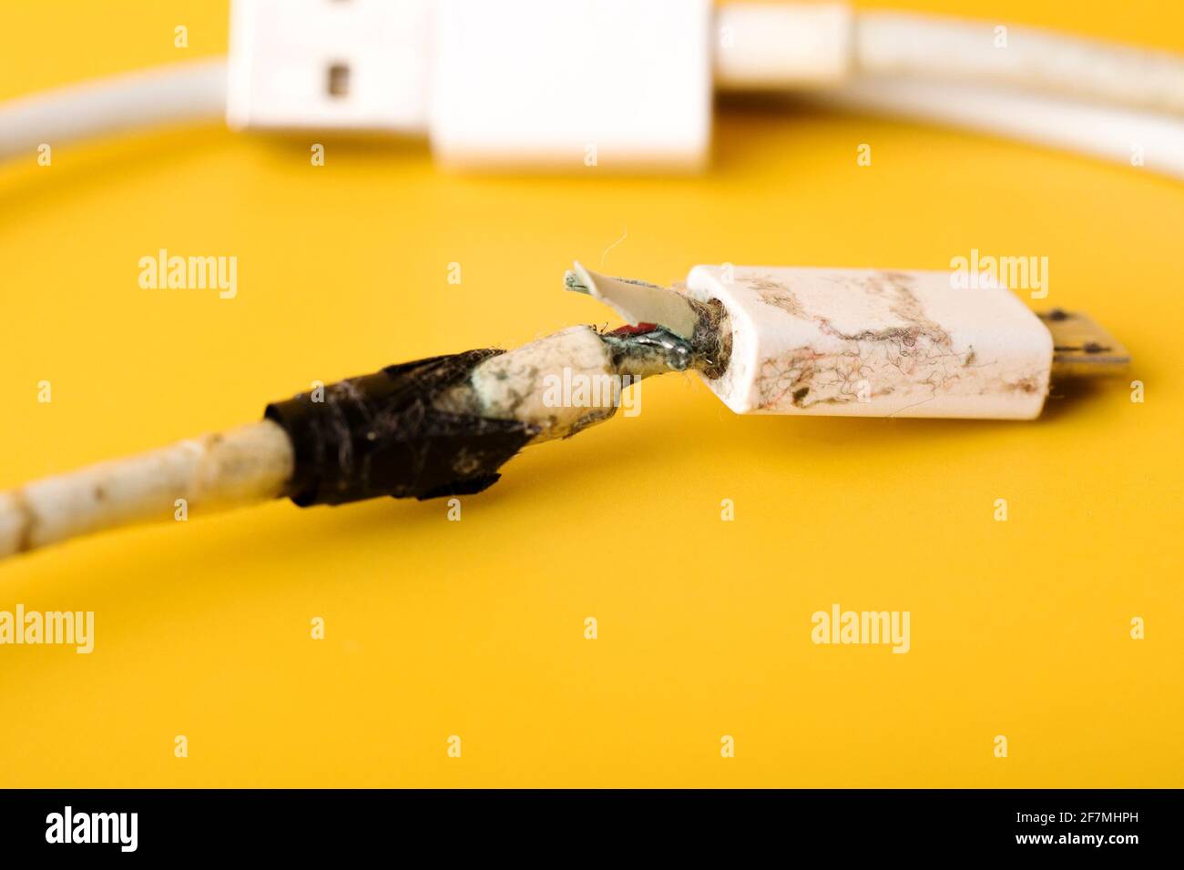 Broken micro USB phone charging cable. Damaged white usb cable plug  bandaged by duct tape Stock Photo - Alamy