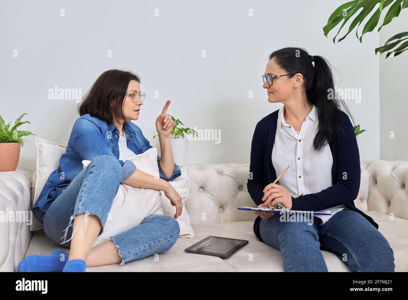 Midlife crisis, mature woman in consultation with psychologist Stock Photo