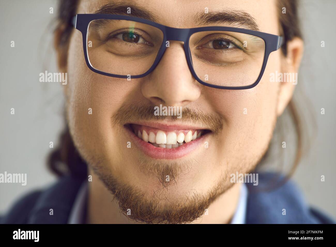 Smart asian man in eyeglasses with smiling expression face portrait close up Stock Photo
