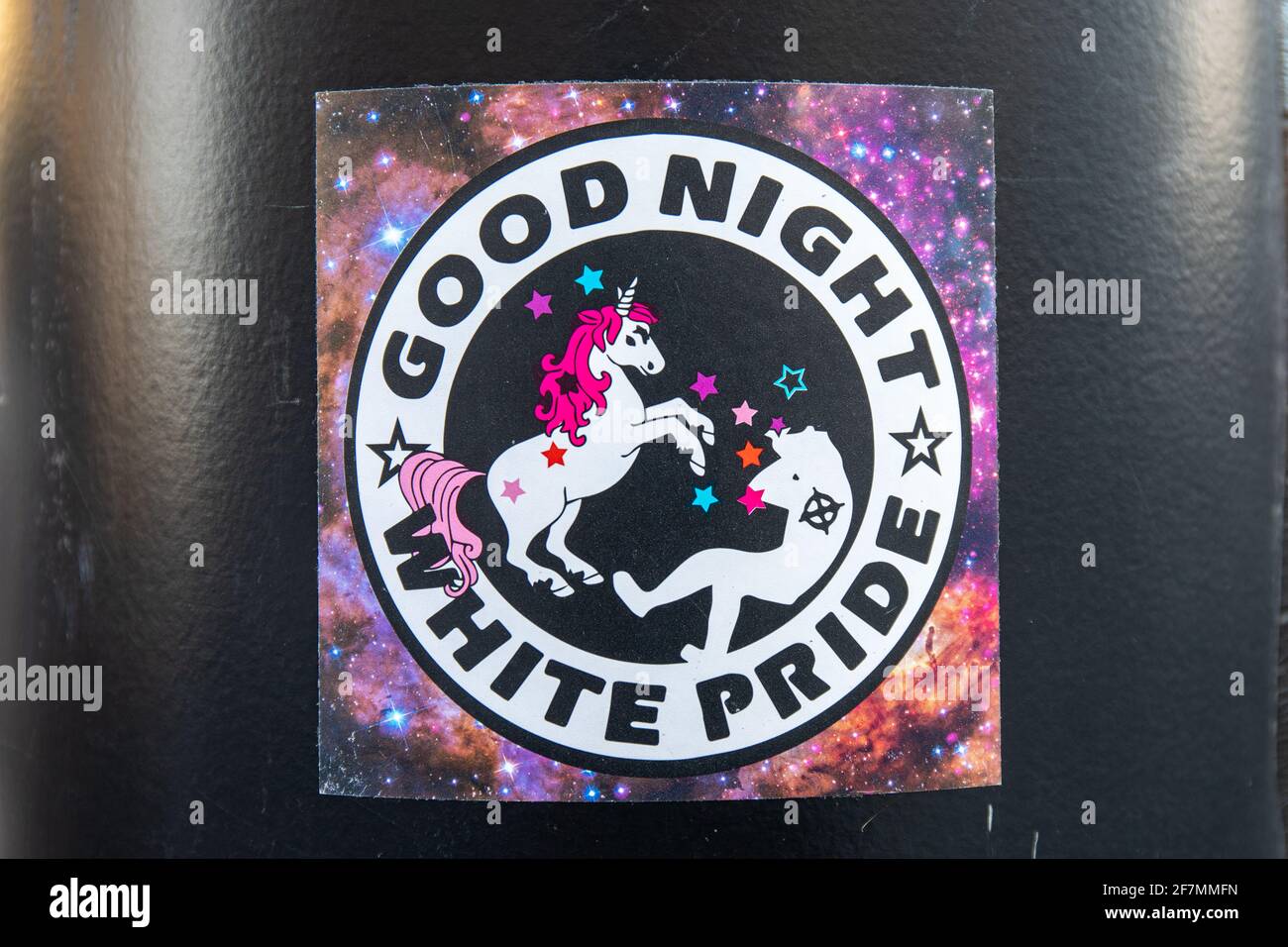 Good night white pride. Anti-racism sticker on a light pole in Helsinki, Finland. Stock Photo