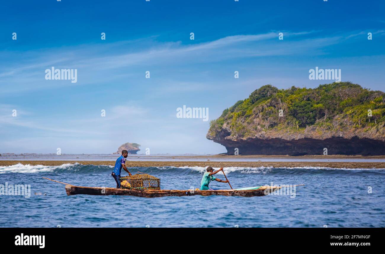 Wasini island, Kenya, AFRICA - February 26, 2020: Two fishermen with a large net on a typical wooden canoe in the Indian Ocean. Stock Photo