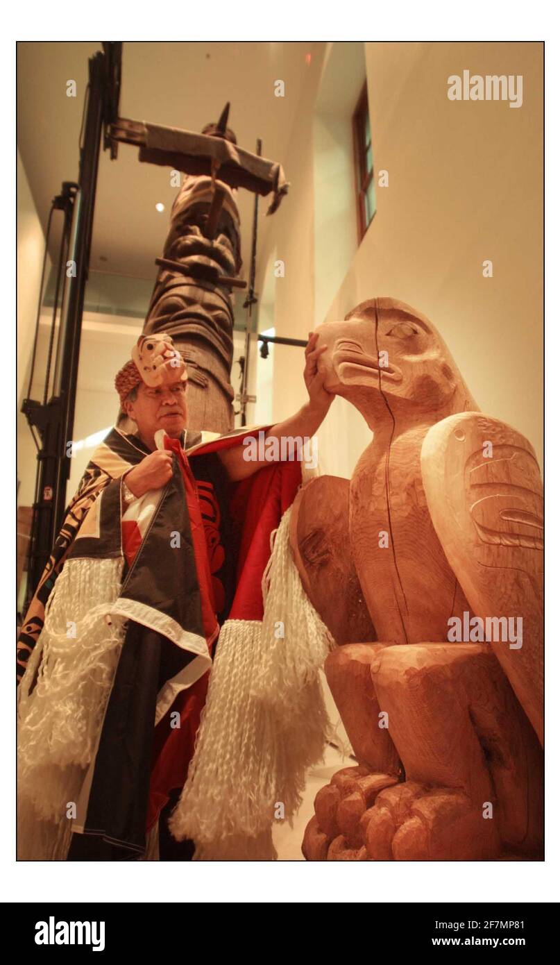 An early and important TOTEM POLE from the Nisga'a Nation, British Colombia raised into position at the British Museum with Chief Gadeelip (literally 'Cheif Anchor') master carver and member of the Nisga'a Eagle-Beaver clan on hand to watch the process. The magnificent 8 meter red cedar pole will be one of the star objects in the forthcoming exhibition LIVING and DYING opening on 3 November.pic David Sandison 17/10/2003 Stock Photo