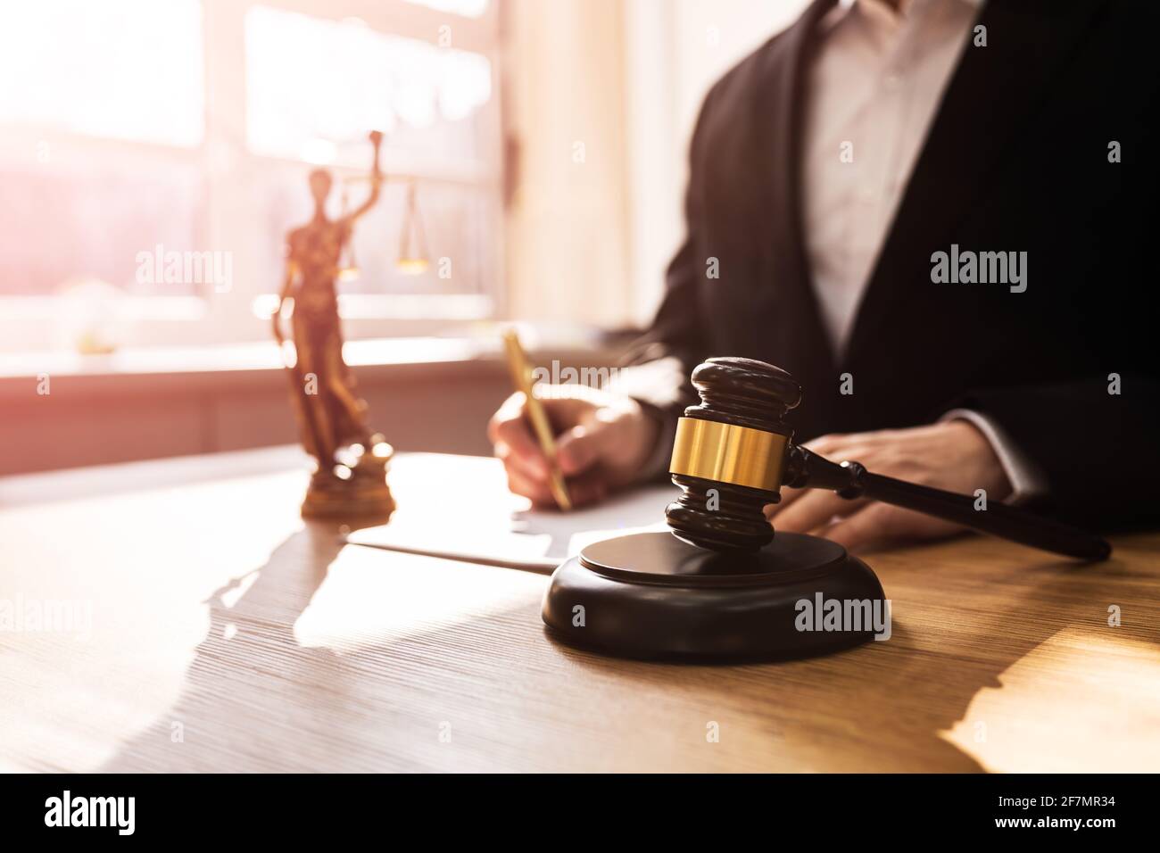 Judge With Gavel In Court Writing Legal Law Order Stock Photo