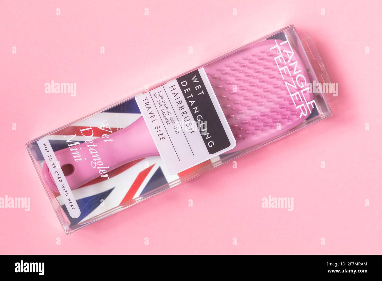 London, United Kingdom - April 8, 2021: Pink Tangle Teezer Mini on pink background Stock Photo
