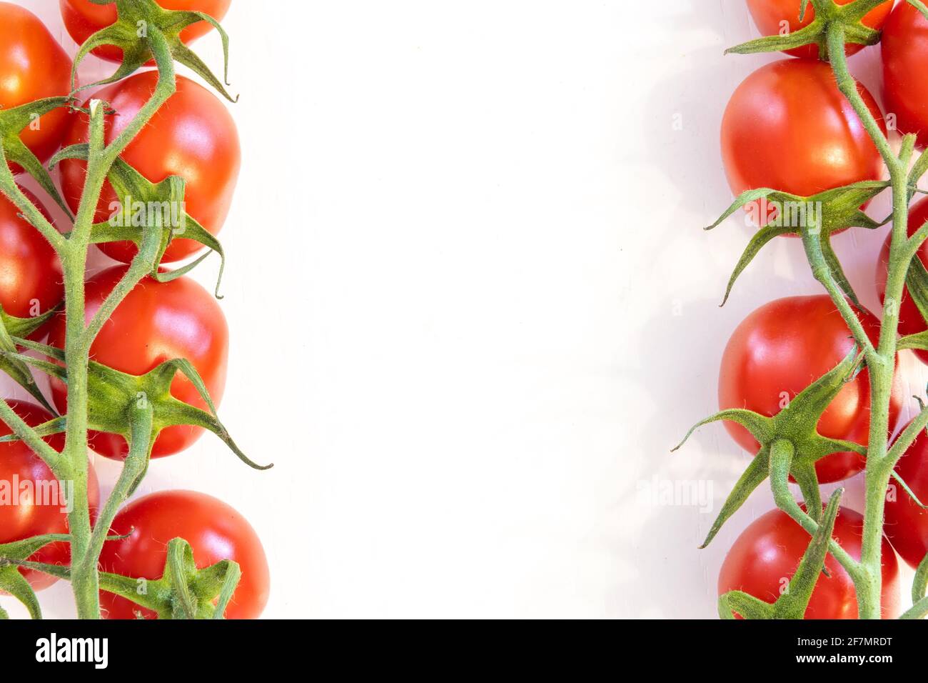 Branch of fresh cherry tomatoes isolated on white background with copy ...