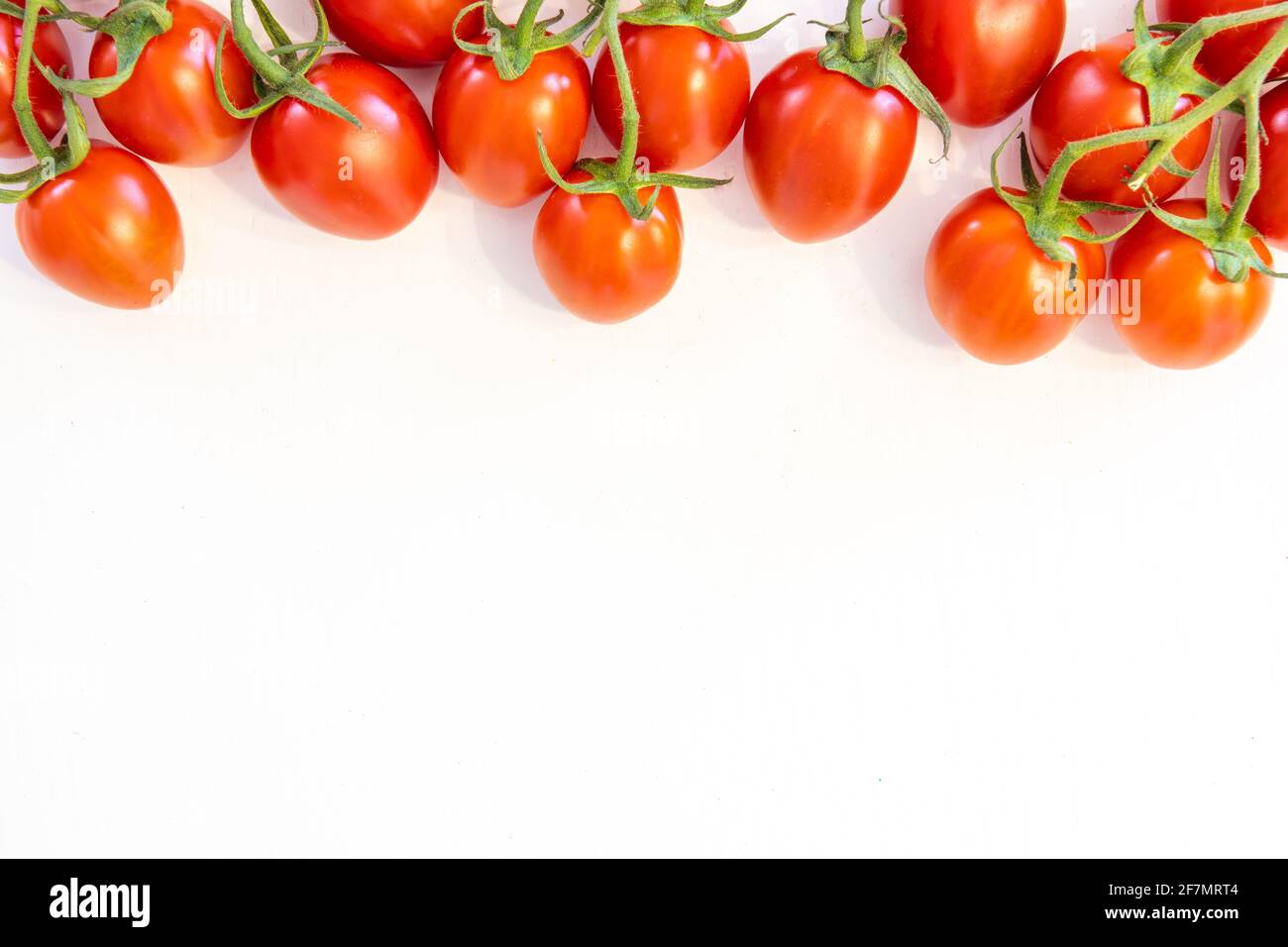 Branch of fresh cherry tomatoes isolated on white background with copy ...