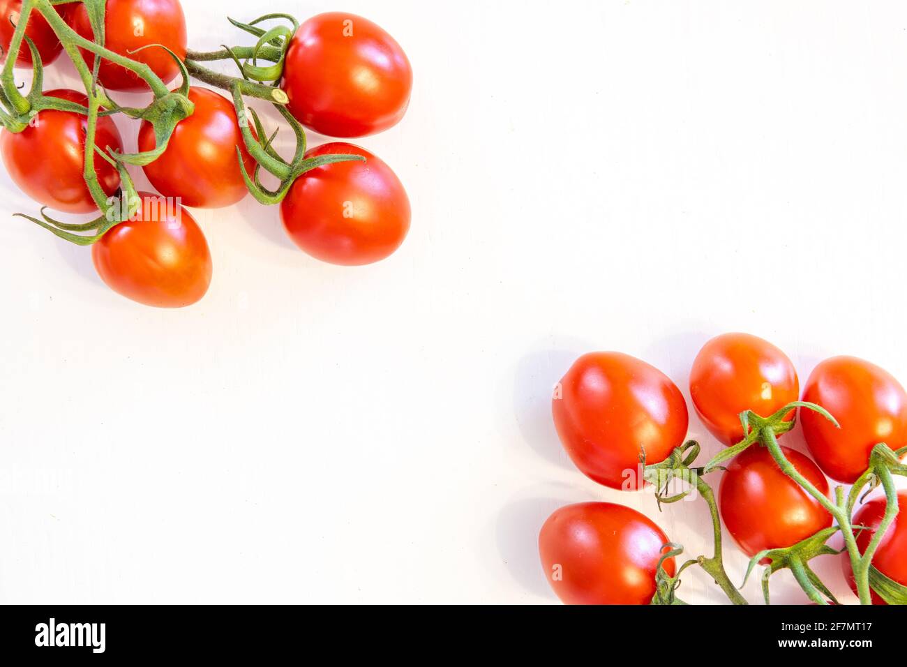 Branch of fresh cherry tomatoes isolated on white background with copy ...