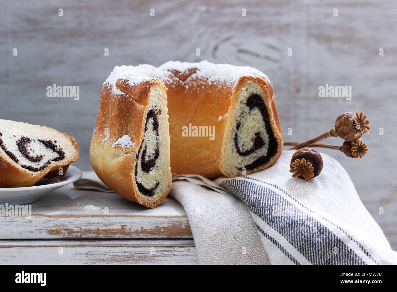 Poppy seed cake made from yeast dough and coffee on a light background