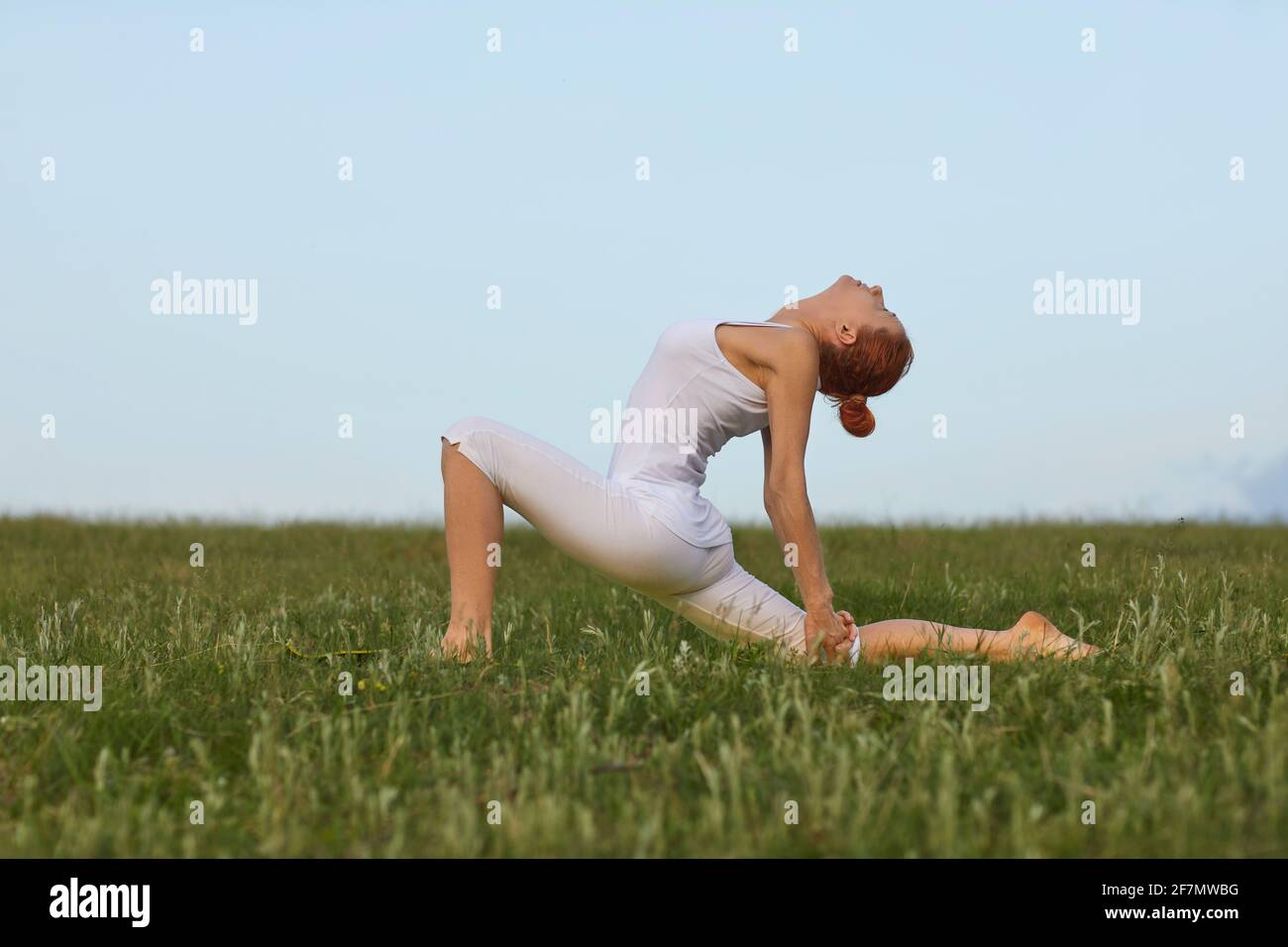 Fit female doing Crescent Lunge on the Knee Stock Photo
