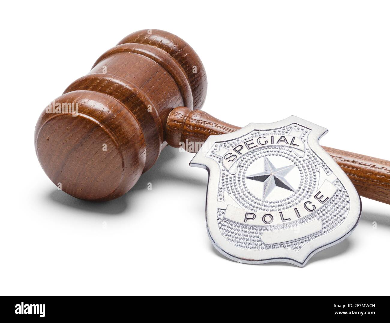 Wooden Judges Gavel and Metal Police Badge Cut Out. Stock Photo