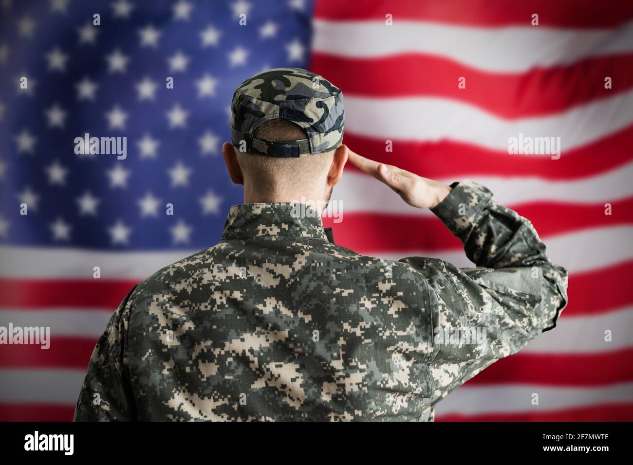 Military US Soldier Saluting Flag. Army Veteran Stock Photo