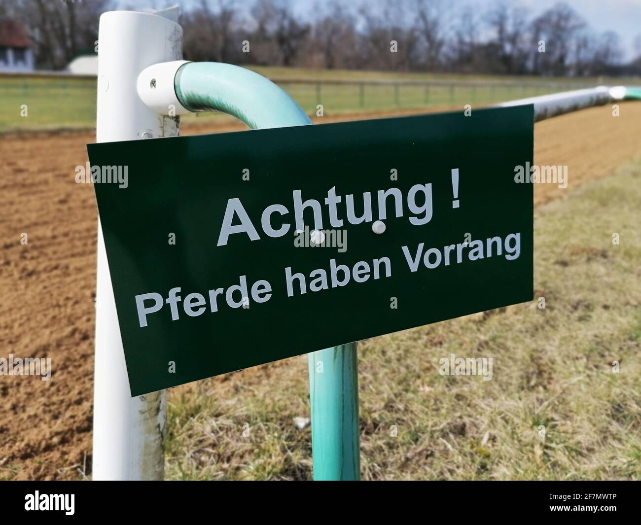 Sign at a racecourse in Magdeburg in Germany with the words Attention horses have priority Stock Photo