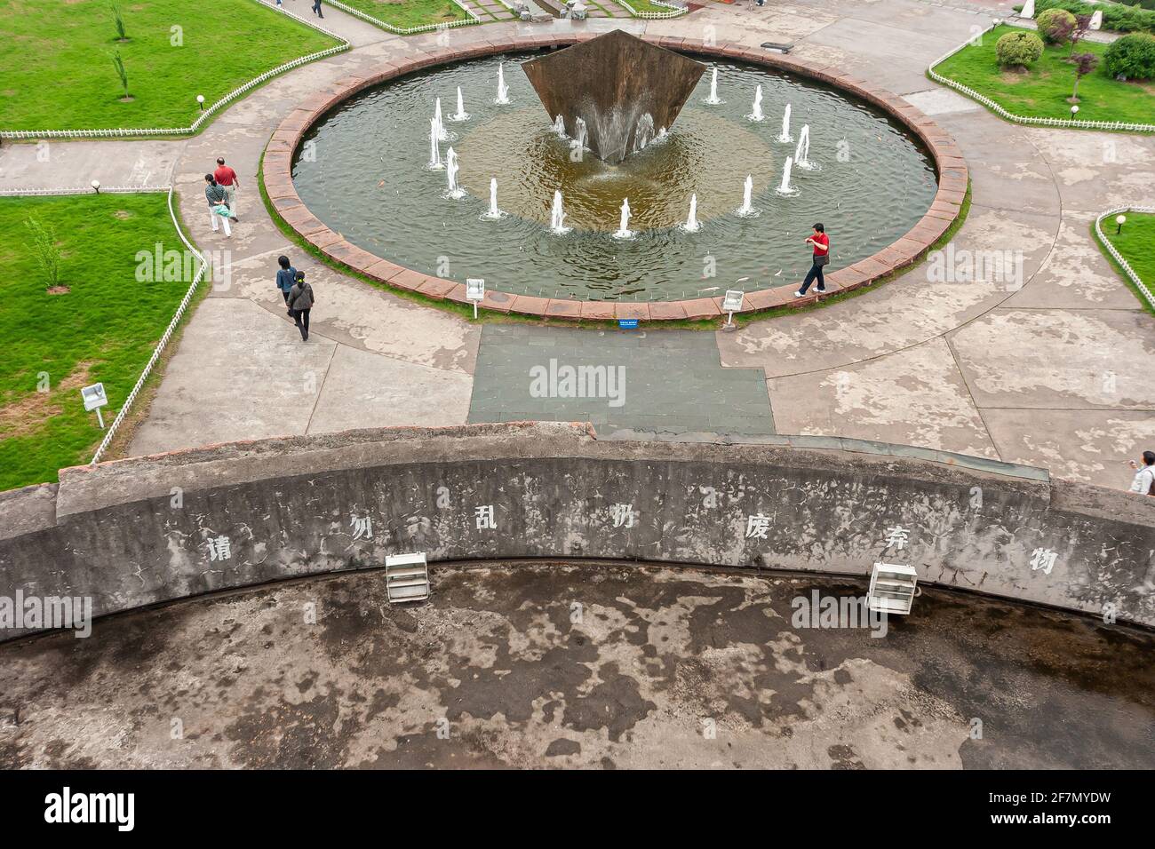 Three Gorges Dam, China - May 6, 2010: Yangtze River. Aerial view on large fountain near visitor center with people around. Green lawn, cement stones, Stock Photo
