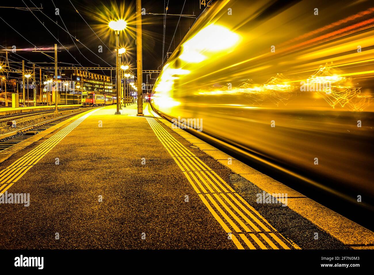 Long exposure shot of a train entering the central station, shot in Fribourg, Switzerland Stock Photo