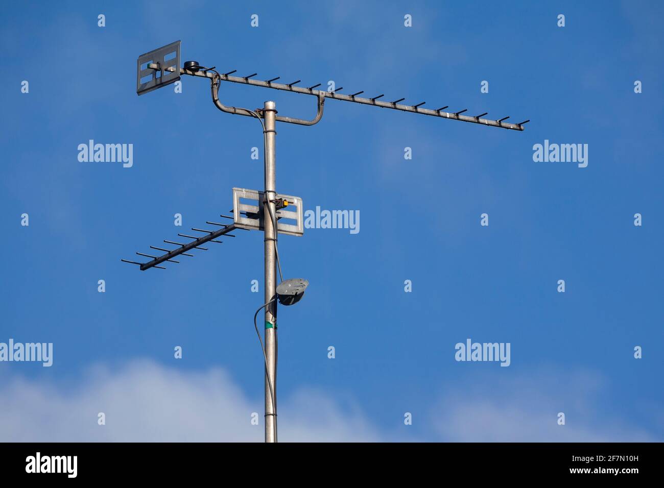Television aerials against a blue sky Stock Photo