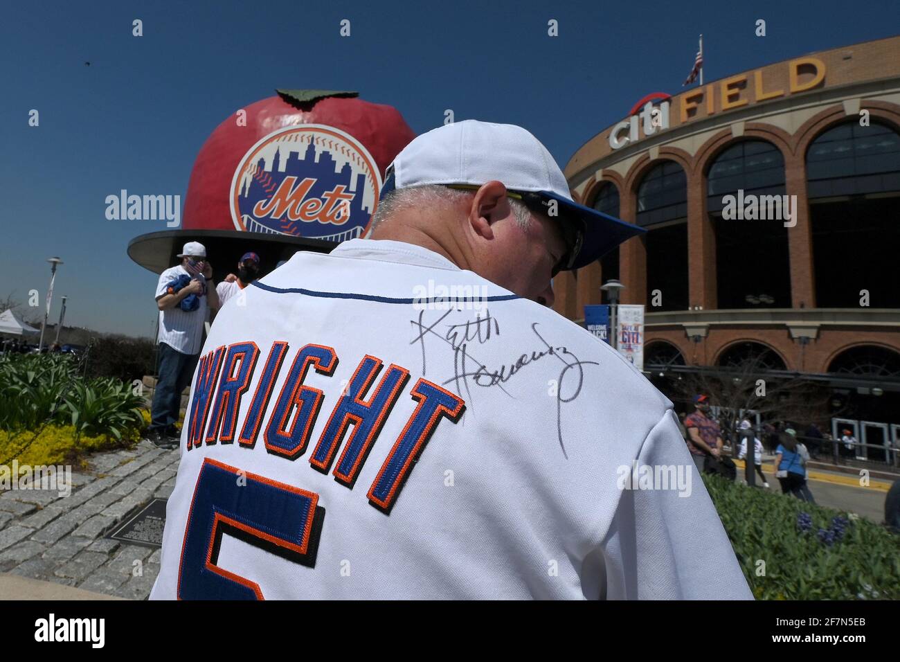 New York, USA. 08th Apr, 2021. A man shows off a baseball shirt signed by  former Mets player Keith Hernandez outside Citi Field before attending the  New York Mets home opening game
