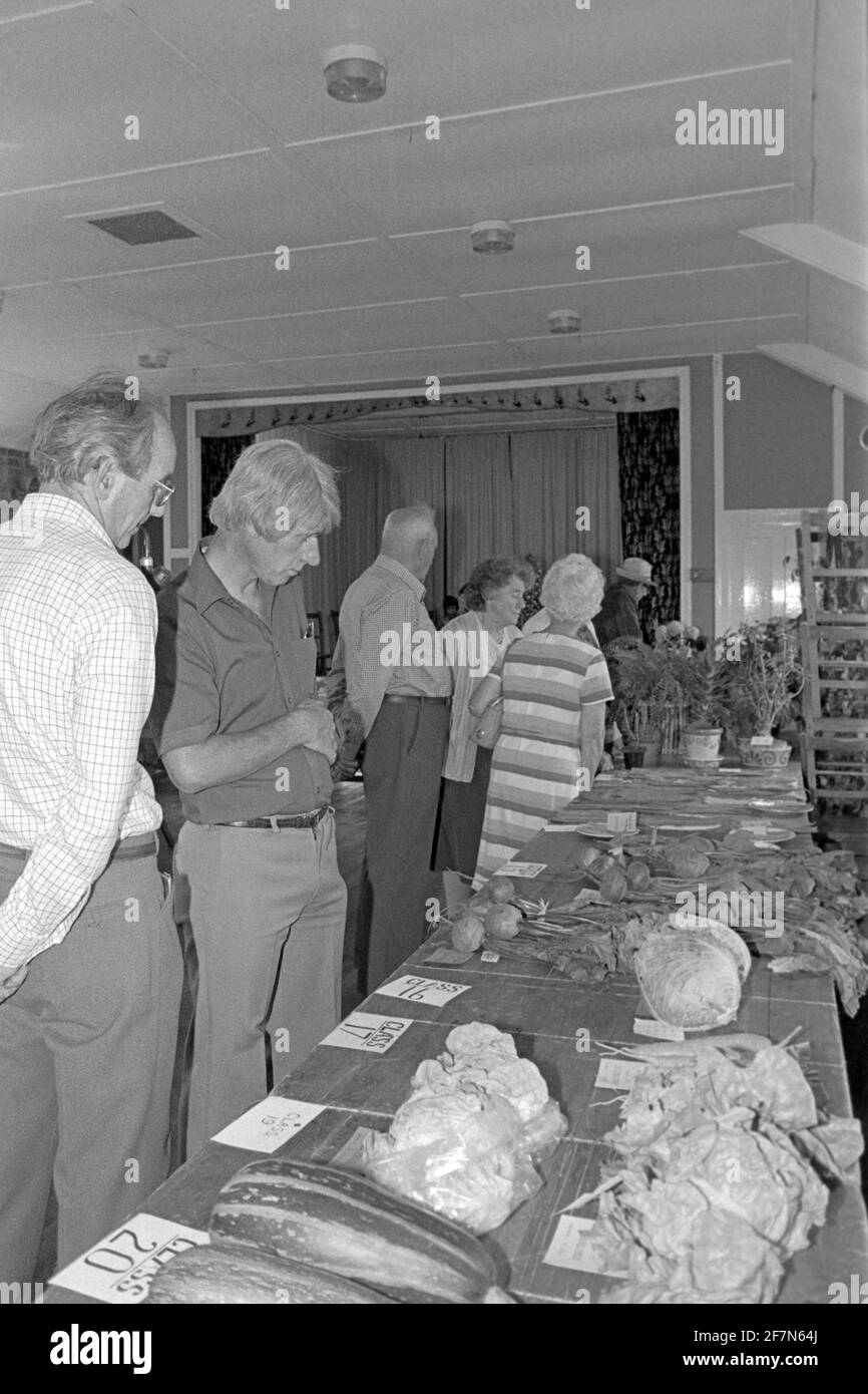 table with fresh vegetables for judging in contest at traditional indoor church hall fete bring and buy jumble sale late 1970s uk Stock Photo