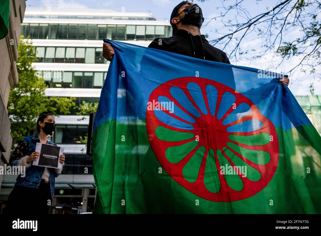 A man holds a gypsy flag during the demonstration. As part of the  International Day of the Gypsy People, the Gypsy community in Madrid  demonstrate on the street Marques de la Ensenada