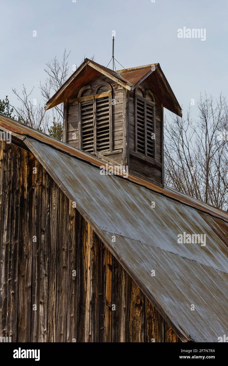 Cupola with lightning rod atop metal clad gambrel room on barn at Bufka