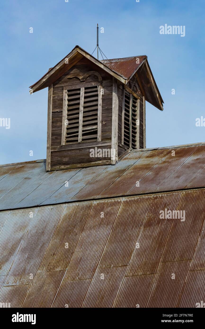 Cupola with lightning rod atop metal clad gambrel room on barn at Bufka