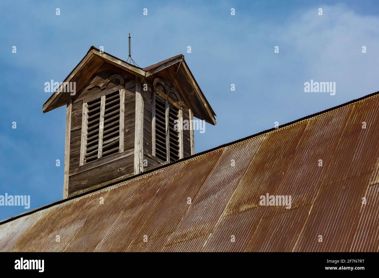 Cupola with lightning rod atop metal clad gambrel room on barn at Bufka