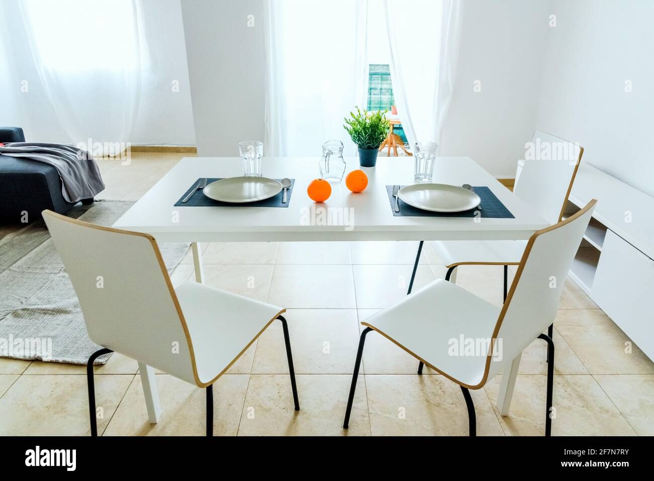 Simple white table in a very simple and bright minimalist living room ...