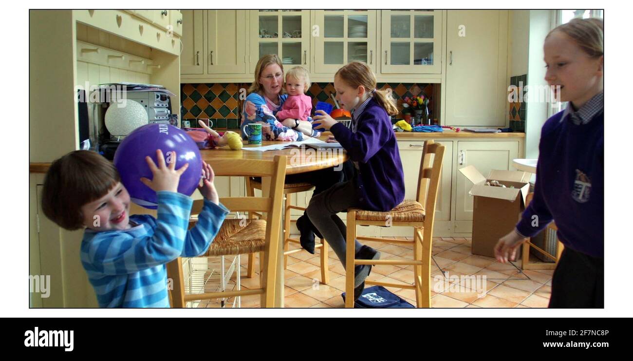 Joanna Moorehead with daughters Rosie 11,Elinor 8, Miranda 4 and Catrina 1 at home in south west London.pic David Sandison 3/4/2003 Stock Photo