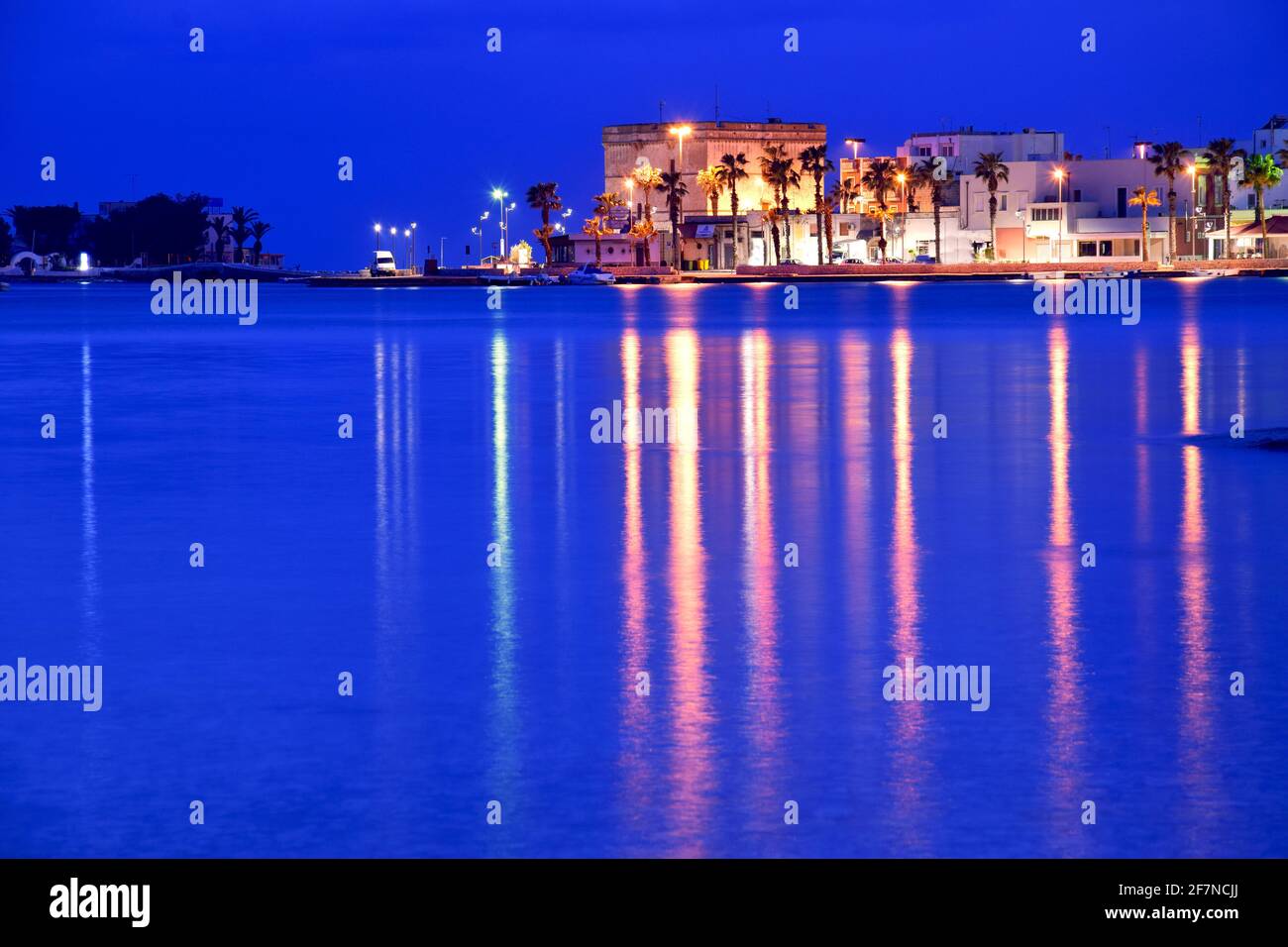 View of the harbour at night in Porto Cesareo Stock Photo