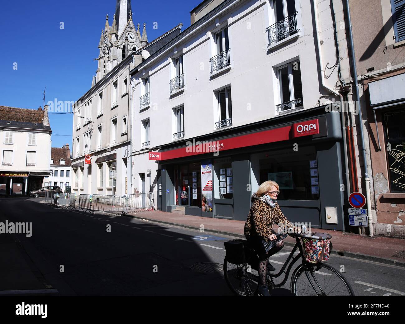Montargis, France. 8th Apr, 2021. A woman rides a bicycle in Montargis, central France, on April 8, 2021. More than 10 million people have received a first COVID-19 vaccine dose in France, Prime Minister Jean Castex announced on Thursday, pledging to quickly expand the vaccination rollout. Credit: Gao Jing/Xinhua/Alamy Live News Stock Photo
