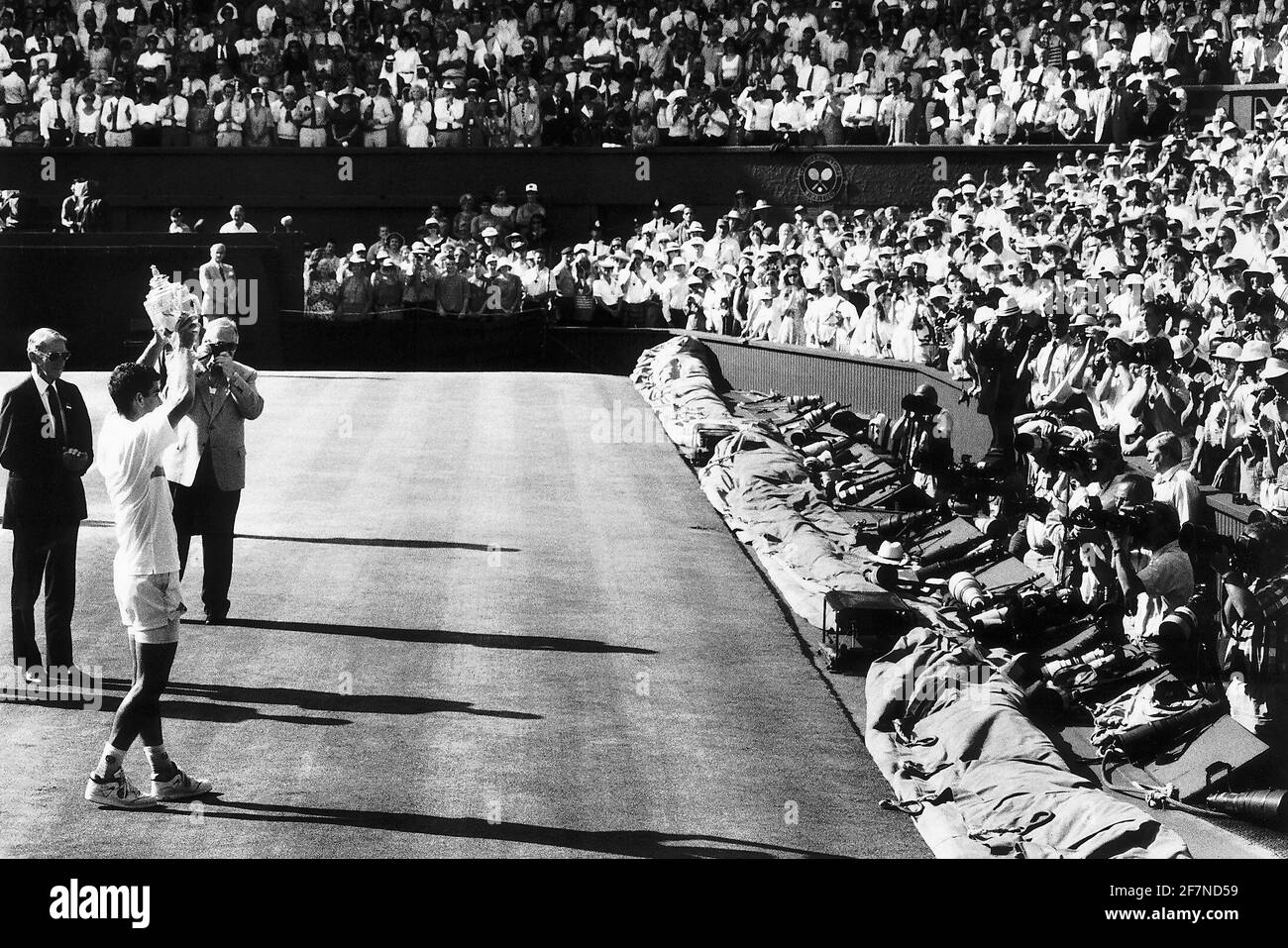 Pete Sampras tennis player holding Wimbledon mens singles trophy aloft for photographers Stock Photo