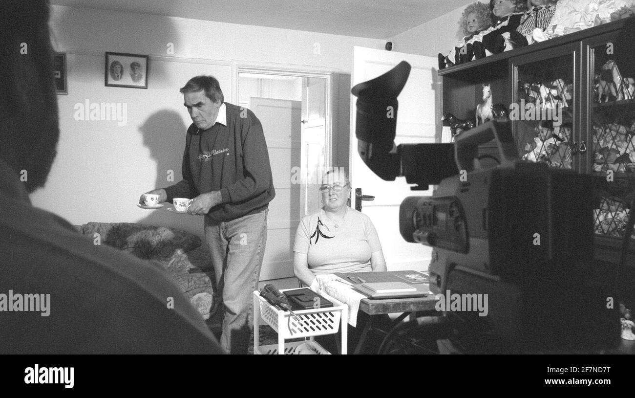 Cameraman Roger Beck On Left Slight Silhouette Of Face Showing Only Talking To And Filming Lily Veares In Her Home For A Filler For The Tv Station She Does Decupage And Makes