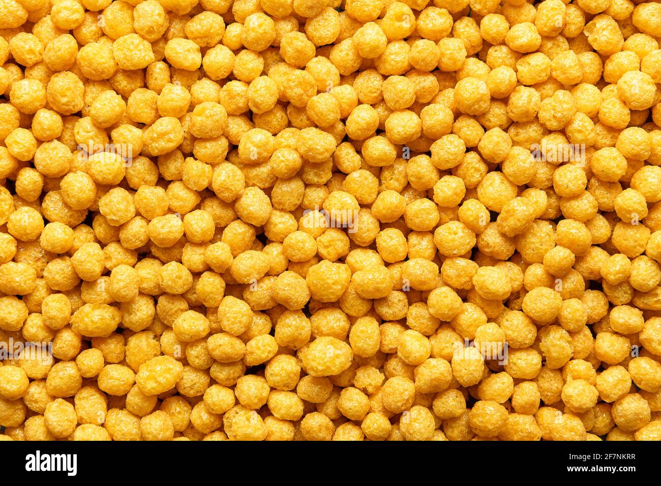 Honey pops breakfast cereals background, flat lay. Full frame with  cornflakes. Delicious corn cereal balls. Macro image with yellow round  cereals Stock Photo - Alamy