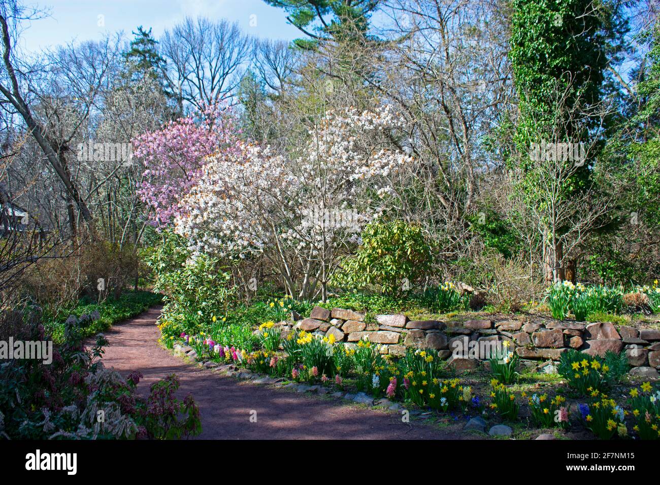 Scenic view of pedestrian walkway and raised flower bed with a stone retaining wall -07 Stock Photo