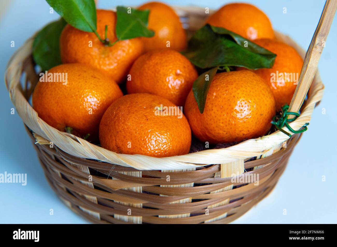 a bowl of oranges on a table Stock Photo