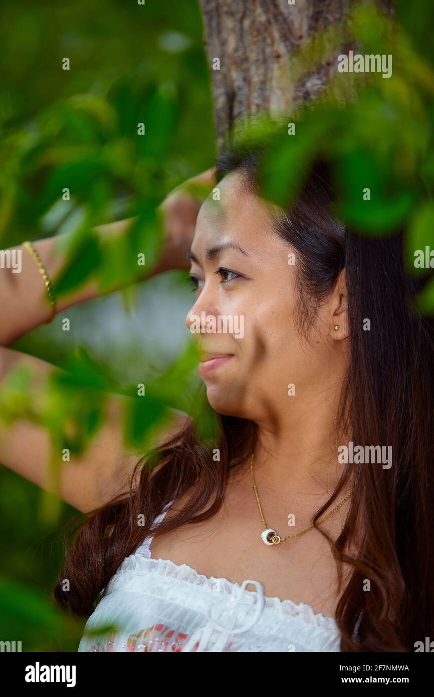 Closeup portrait of young filipino woman outdoors Stock Photo