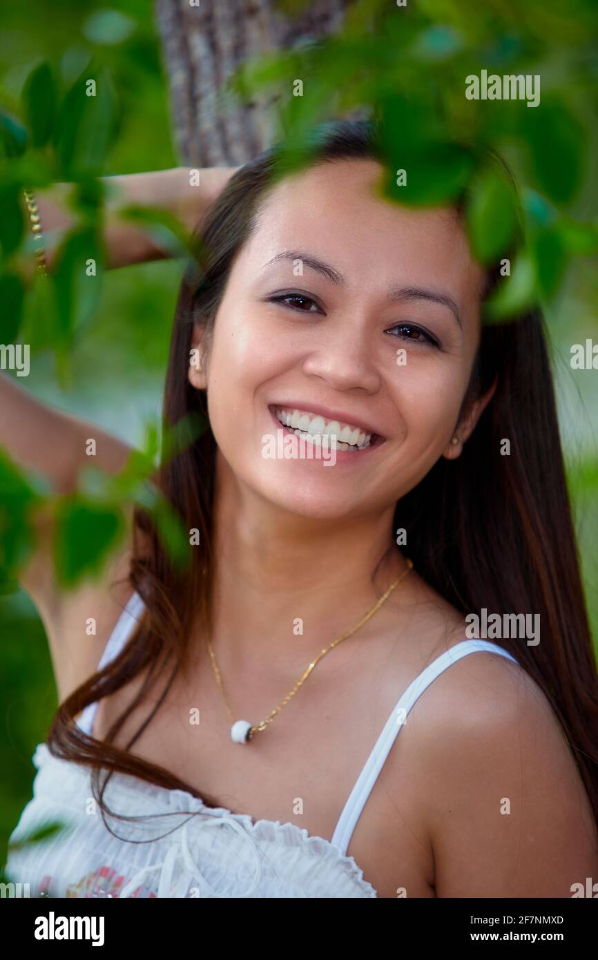 Closeup portrait of young filipino woman outdoors Stock Photo