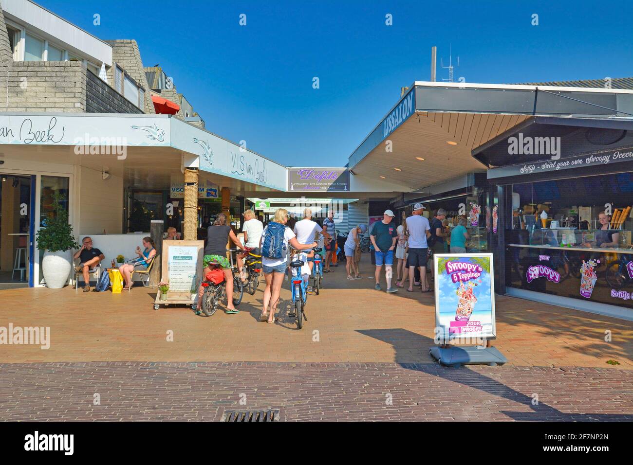 De Koog, Texel  Netherlands - August 2019: Tourists buying ice cream at ice parlor on sunny summer day Stock Photo