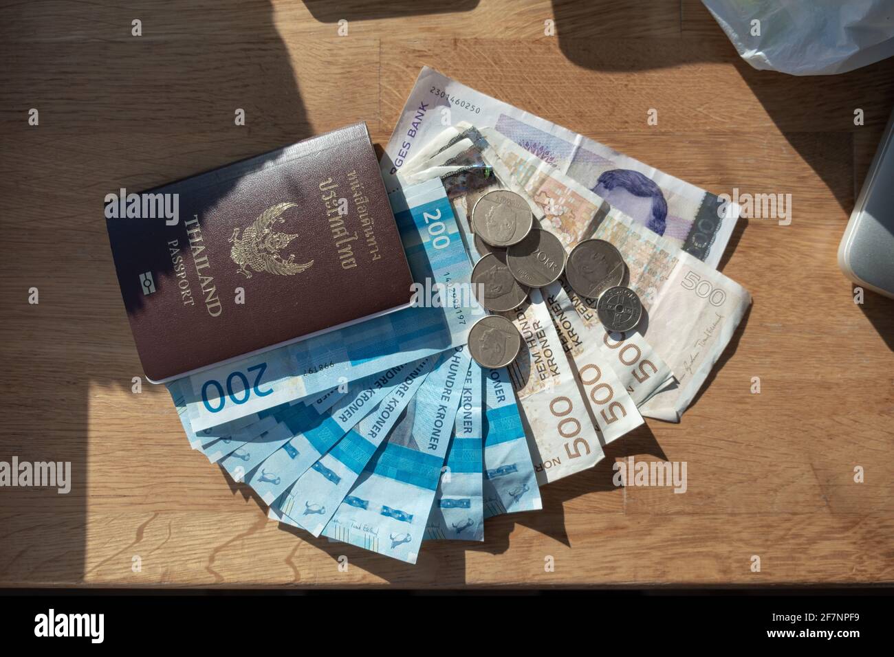Currency Norway Kroner banknote with Coins and Thailand Passport on wooden  table Stock Photo - Alamy