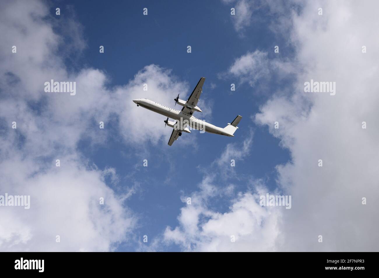 Domestic propeller airplane flying in the blue sky with cloudy Stock ...