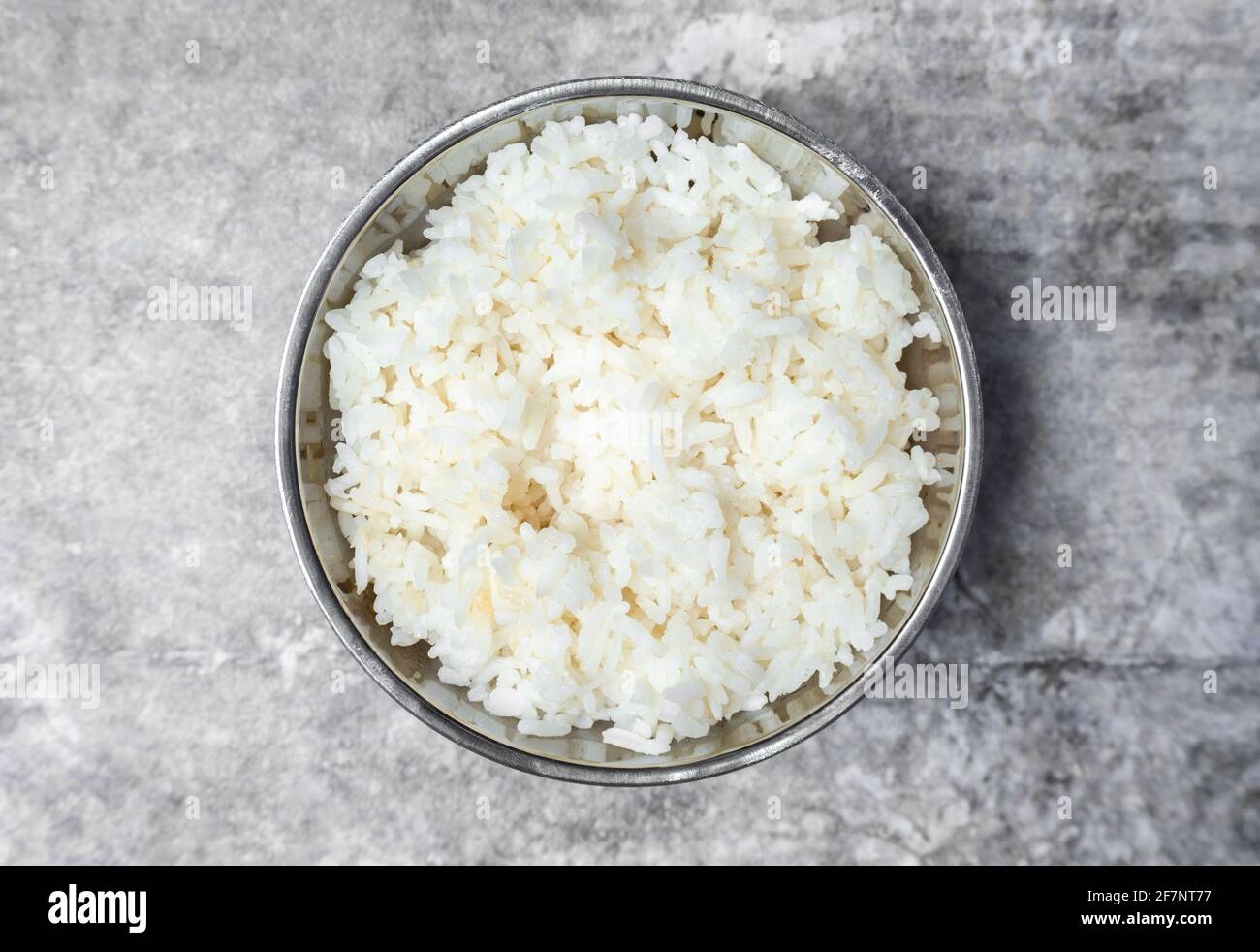Top view steamed rice in stainless bowl on the gray concrete table ...