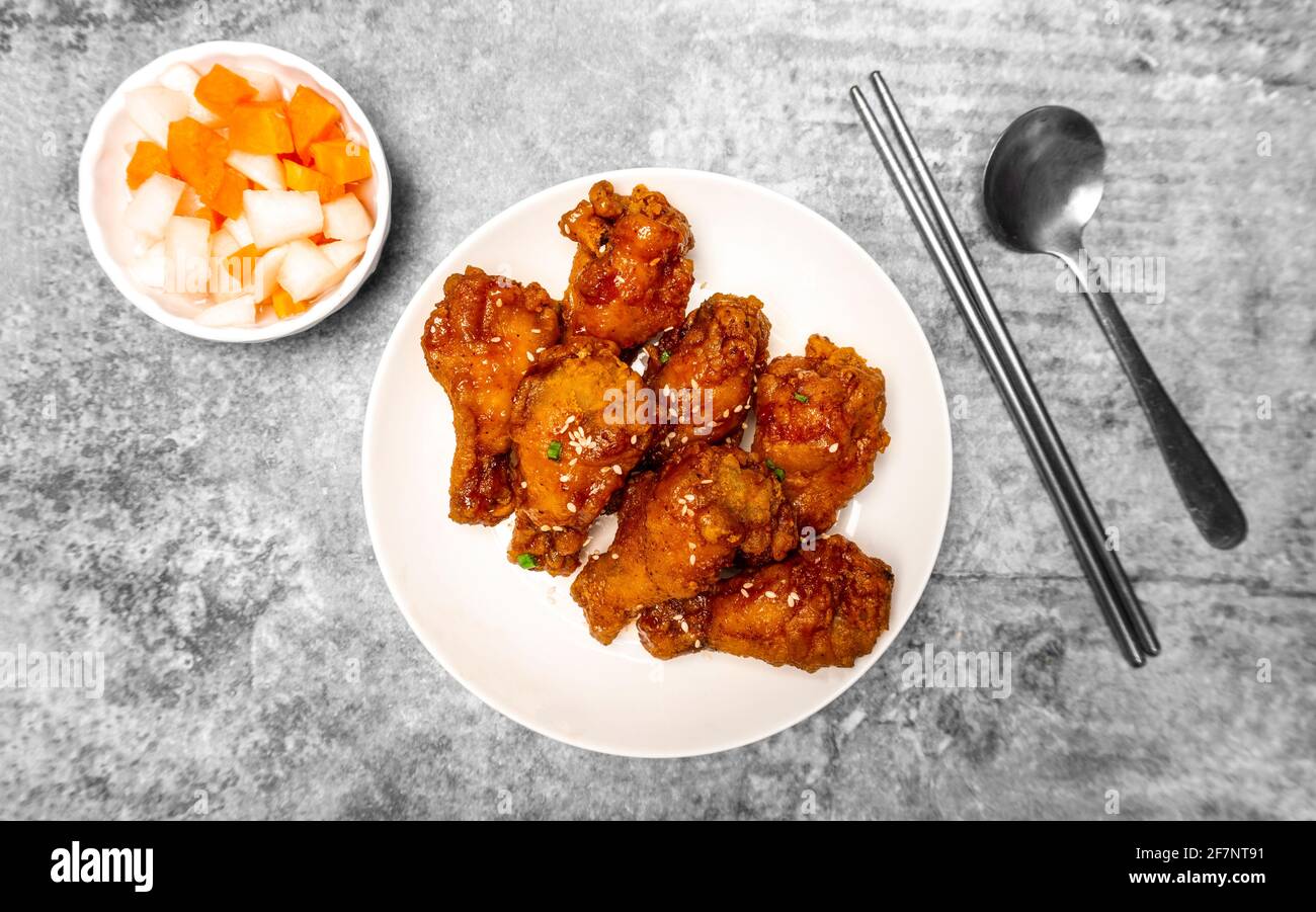 Top view Korean spicy deepfried chicken topped white sesame with
