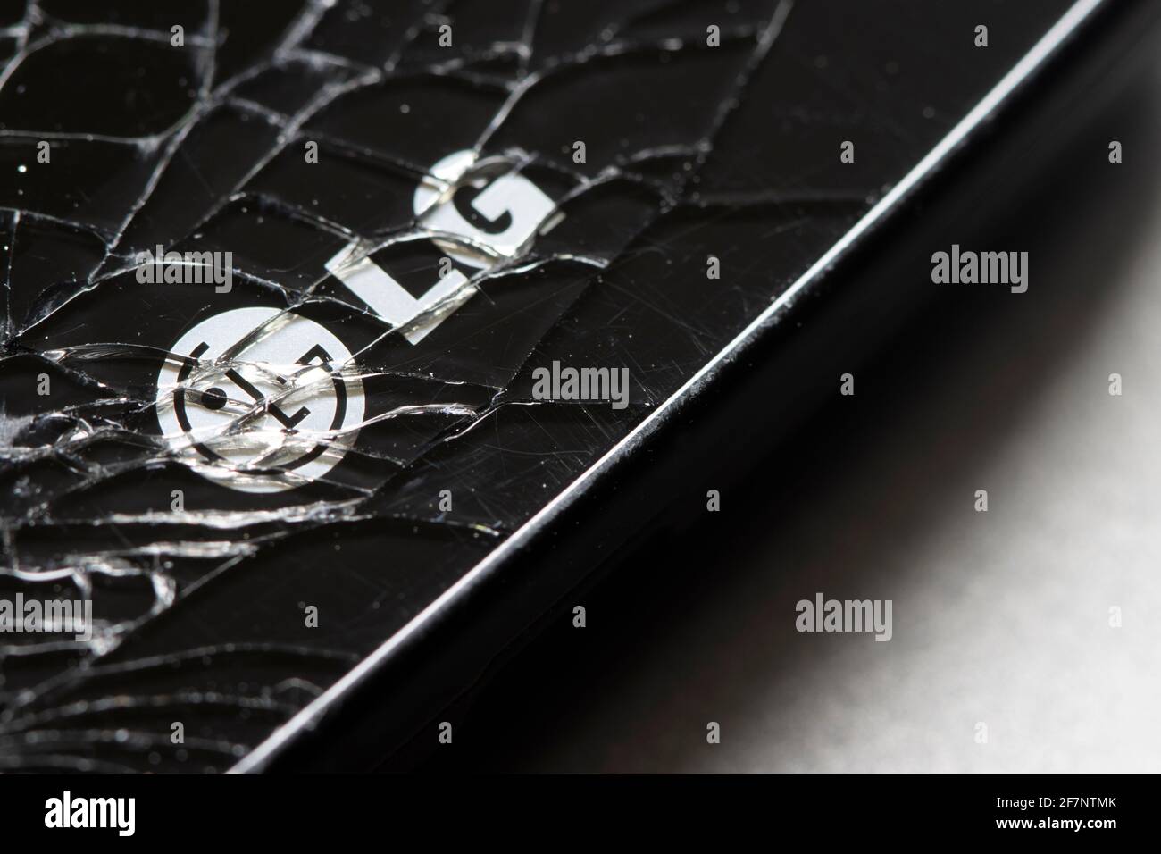 The LG logo is seen on a cracked smartphone on April 8, 2021. LG Electronics has confirmed its rumored exit from the competitive smartphone industry. Stock Photo