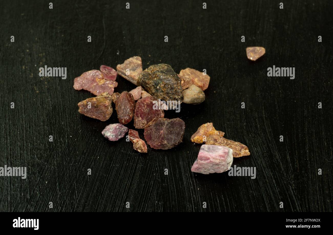 Madagascar or Pakistani Garnet natural mineral stone on black background. Mineralogy, geology, magic of stones, semi-precious stones and samples of mi Stock Photo