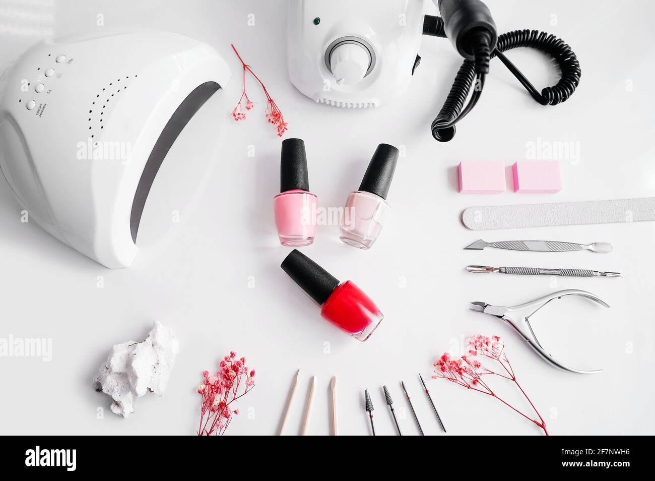 Tools of a manicure set on a white background. Ultraviolet lamp and