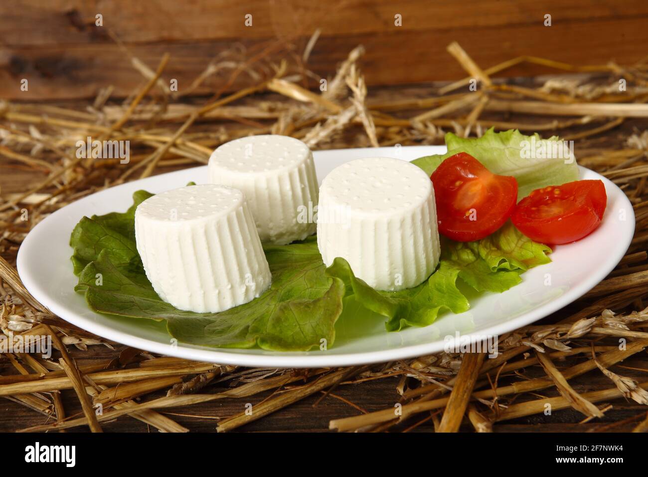 Italian cheese goat's milk ricotta placed on a sheet of salad leaves