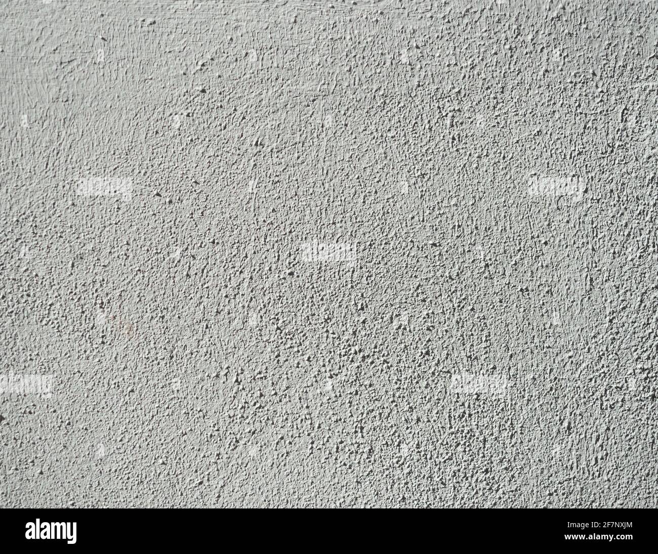 rough white wall textures with harsh sunlight highlighting the texture Stock Photo