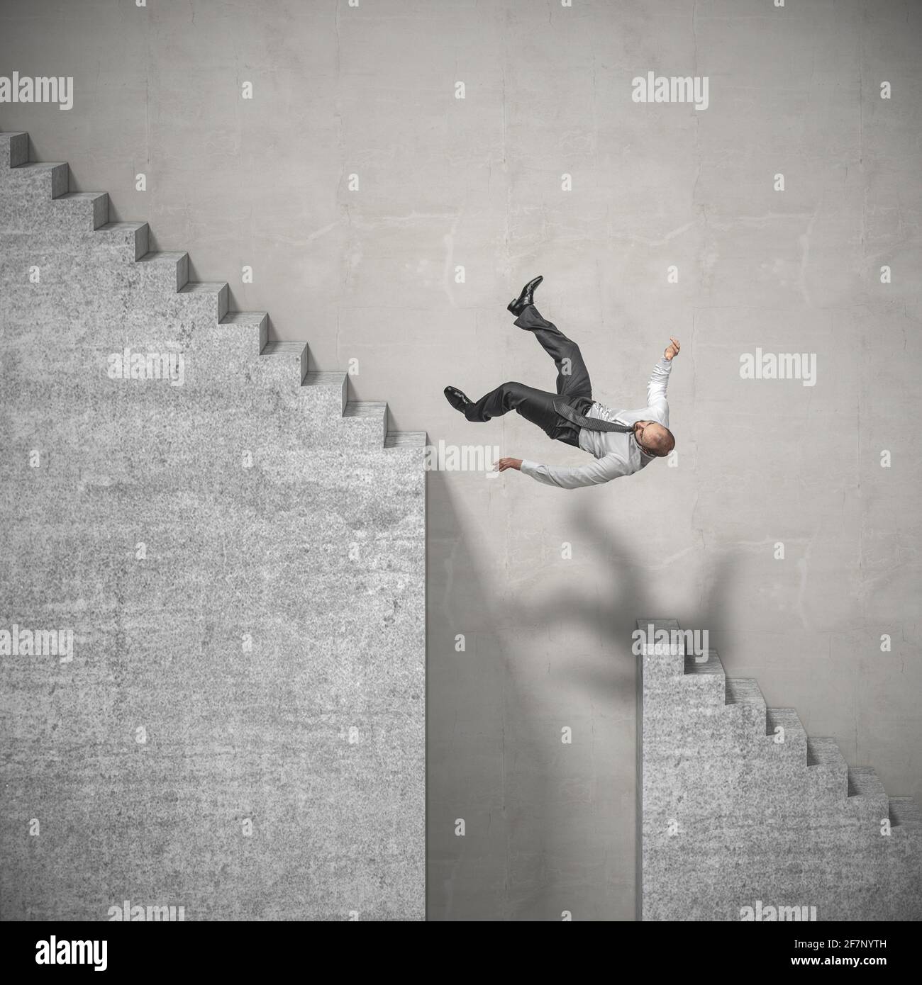 businessman climbs the stairs and falls in a dangerous spot. concept of difficulties at work and challenges. Stock Photo
