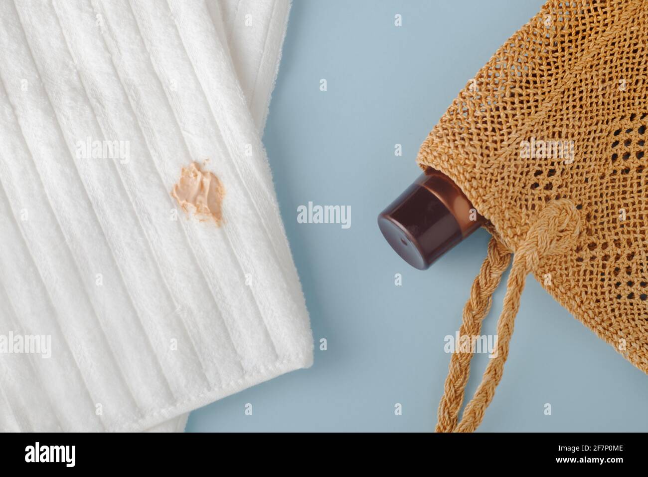 Stains from self-tanner on white towels. Cream in a beach bag. top view Stock Photo