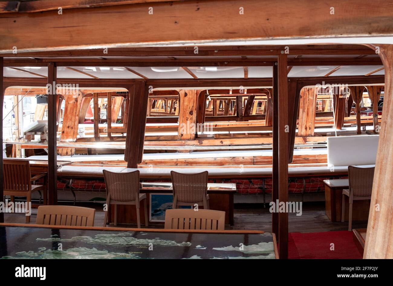 Many empty yachts and boats in the harbor. Pleasure ships stands on pier in port due failed tourist season. Sea excursion. Interior deck Stock Photo